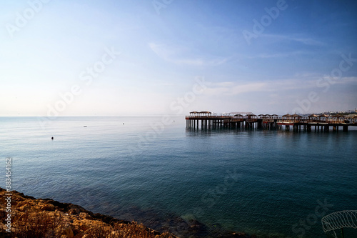 Rocky coast, sea, sky and pier in the background © keleny