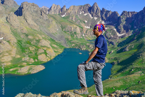 A man on the mountain top and lake view, natural landscape 
