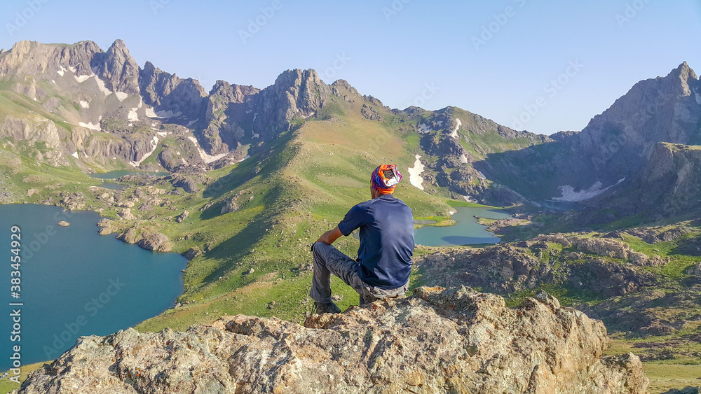 A man on the mountain top and lake view, natural landscape
A man on the mountain top and lake view, natural landscape