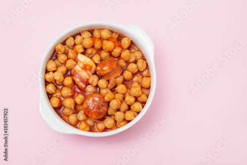 chick-pea with smoked sausage in white bowl