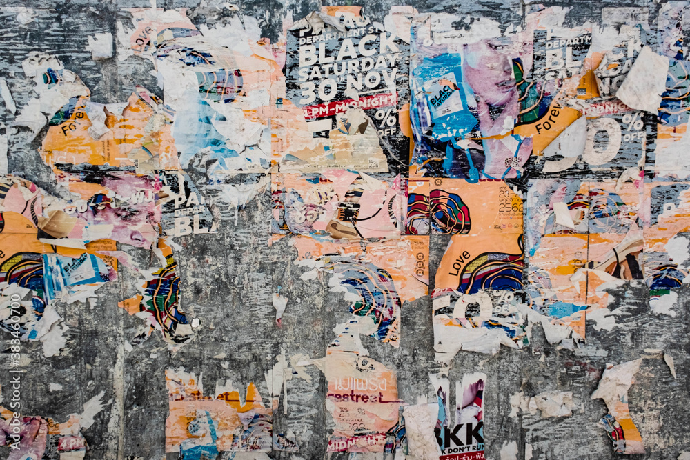 Fototapeta premium Texture of a bright wall with ruptures of posters and advertising. Bright abstract background