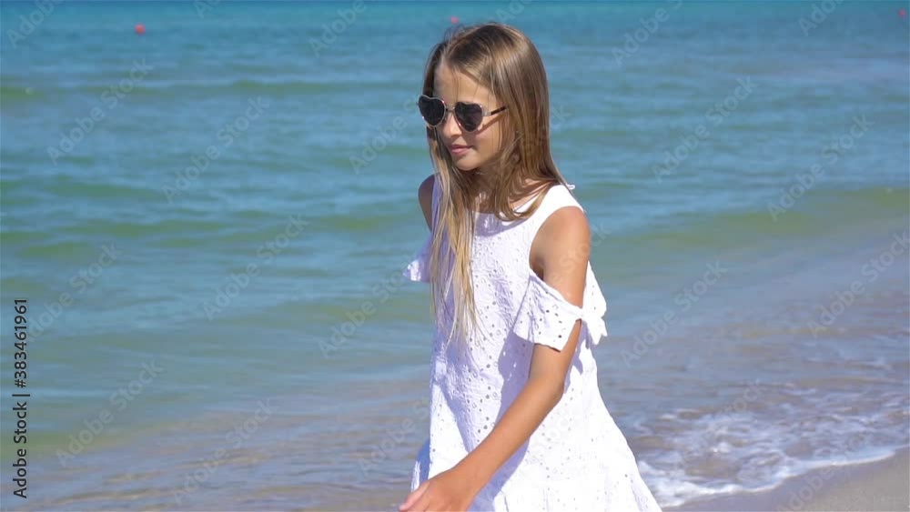 Adorable little girl have fun at tropical beach during vacation Adorable little girl have fun at tropical beach during vacation
