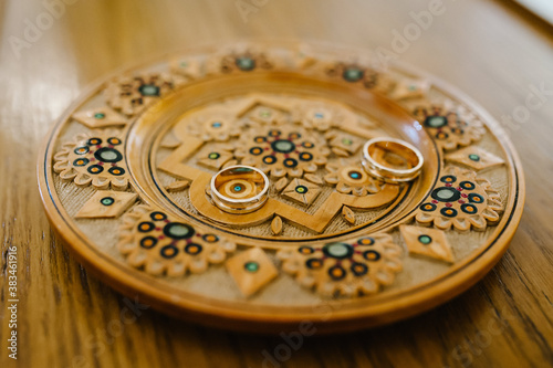 Engagement wedding rings. Gold couple rings on a plate. wedding ceremony in christian church. close up. Selective focus. Photo in motion.