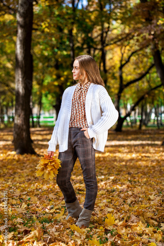 Blonde teenage girl posing in autumn park © Andrey_Arkusha
