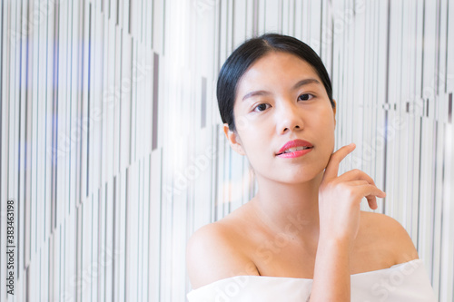 woman applying cream on face