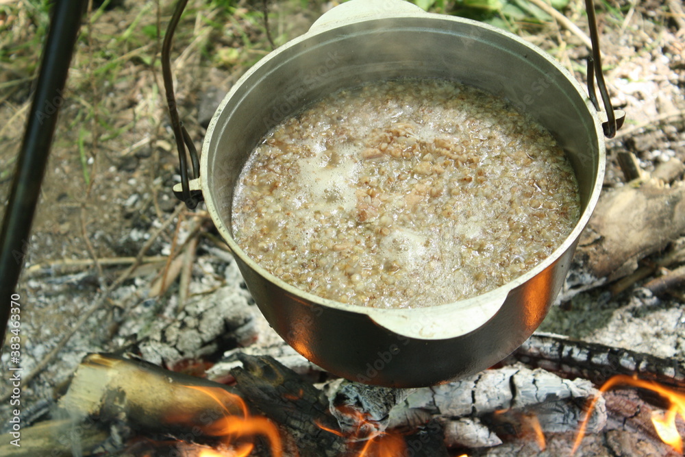 cooking while traveling, cooked porridge in a pot during a picnic cooking while traveling, cooked porridge in a pot during a picnic