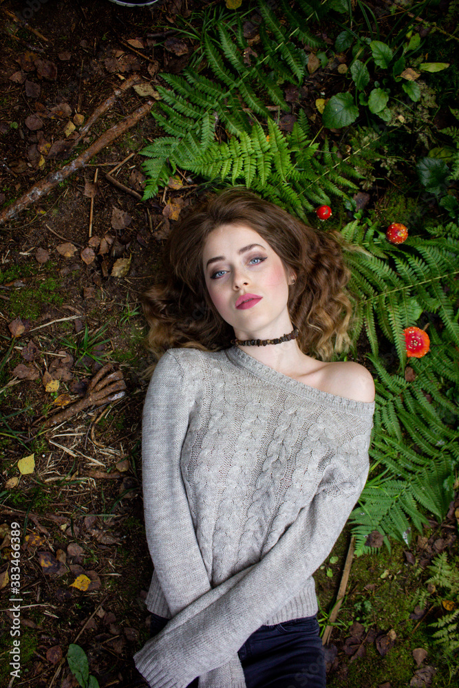 Gothic portrait. The girl lies on the grass. Girl in fern and amanita. Gothic portrait. The girl lies on the grass. Girl in fern and amanita.