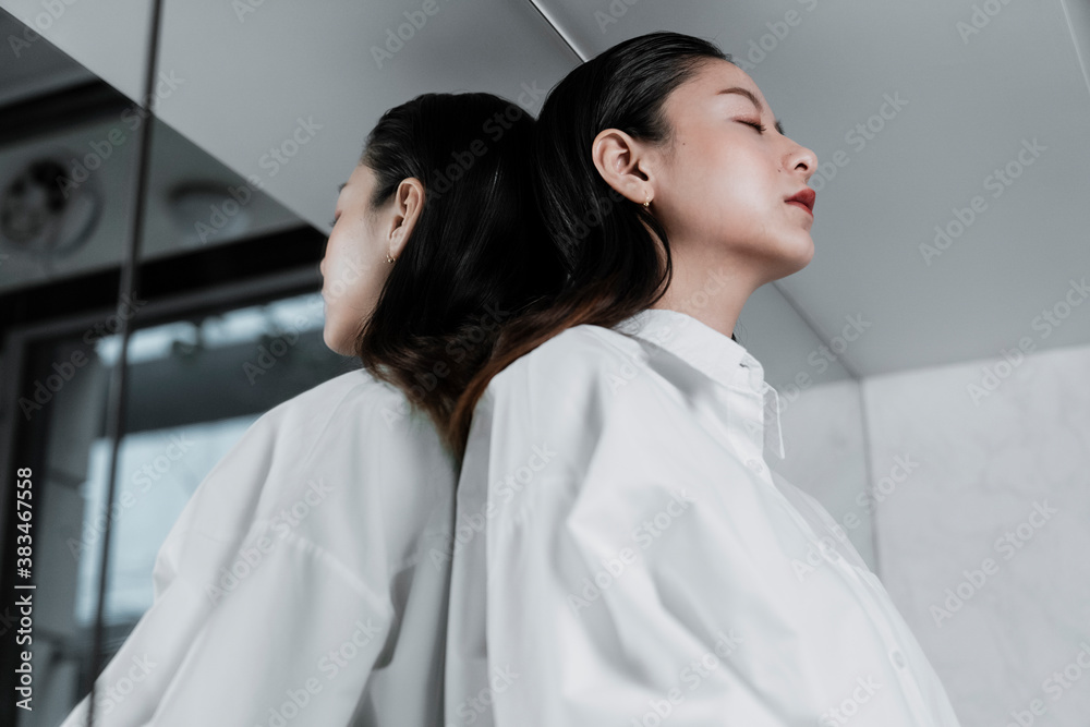 Asian black hair woman leaning on mirror. Asian black hair woman leaning on mirror.