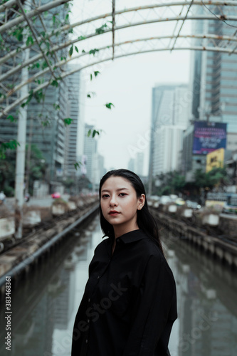 Portrait of woman and river in bangkok city.