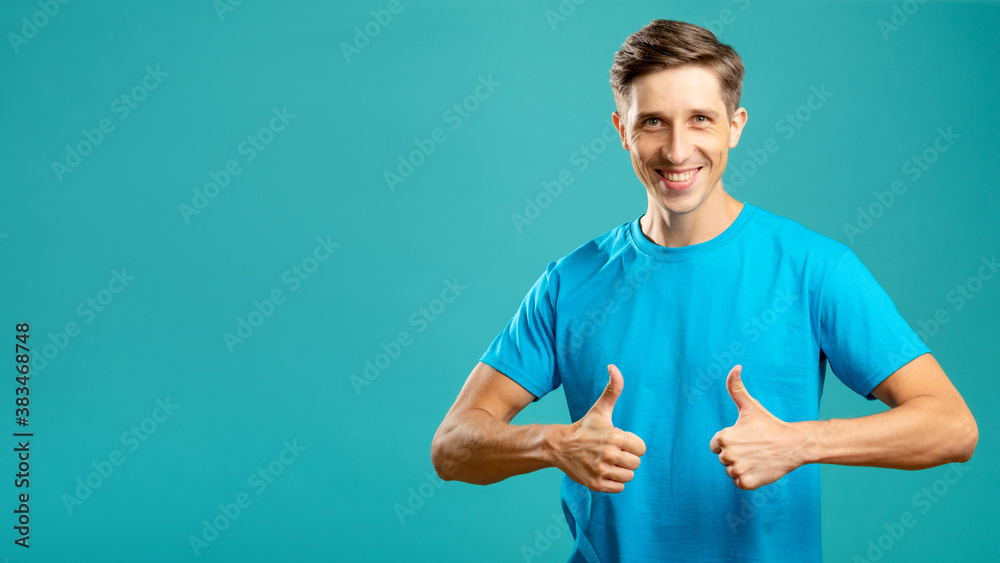 Like gesture. Excited male portrait. Proud support. Nice job. Great achievements. Positive lifestyle. Young happy man holding thumbs up looking at camera isolated on blue copy space. Like gesture. Excited male portrait. Proud support. Nice job. Great achievements. Positive lifestyle. Young happy man holding thumbs up looking at camera isolated on blue copy space.