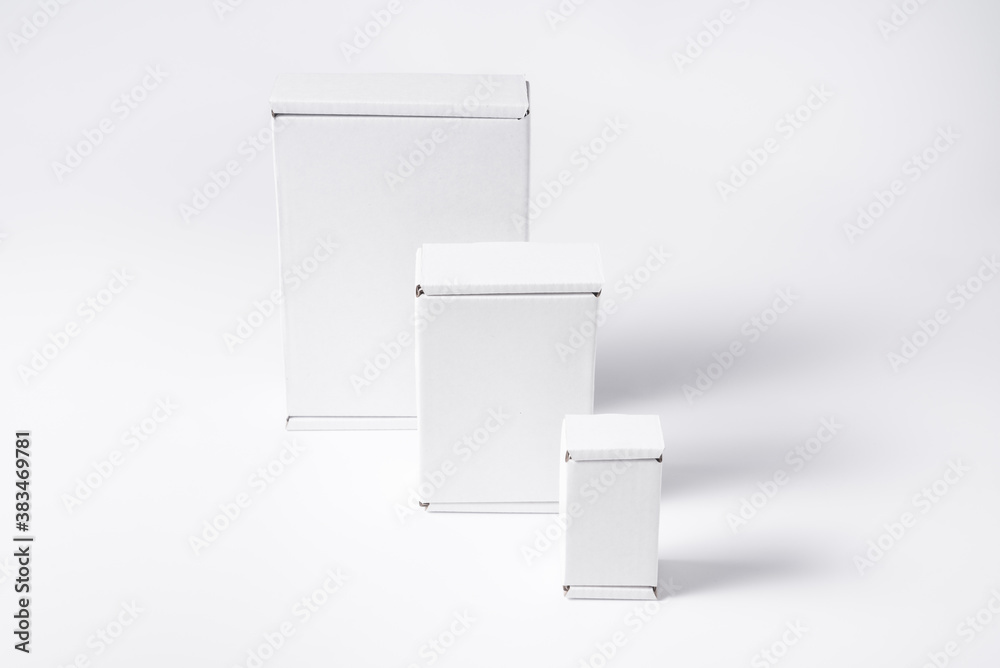 Set of different white cardboard, carton flat boxes on background Set of different white cardboard, carton flat boxes on background