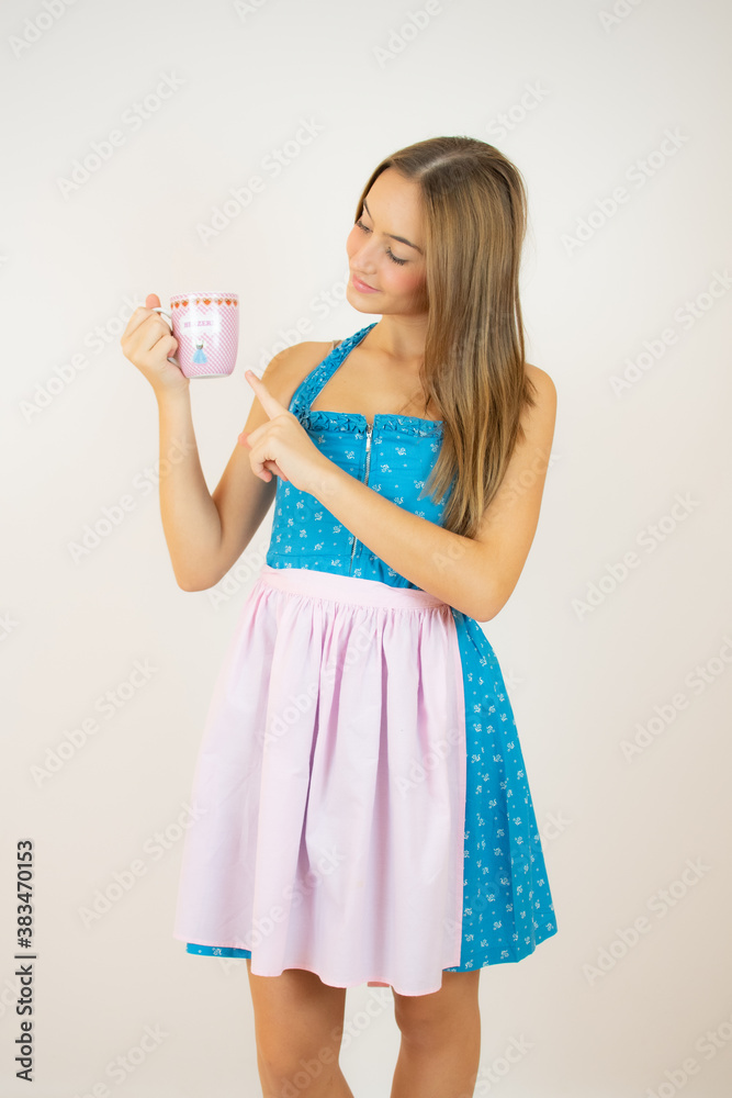 Beautiful bavarian girl with a cup over white background Beautiful bavarian girl with a cup over white background