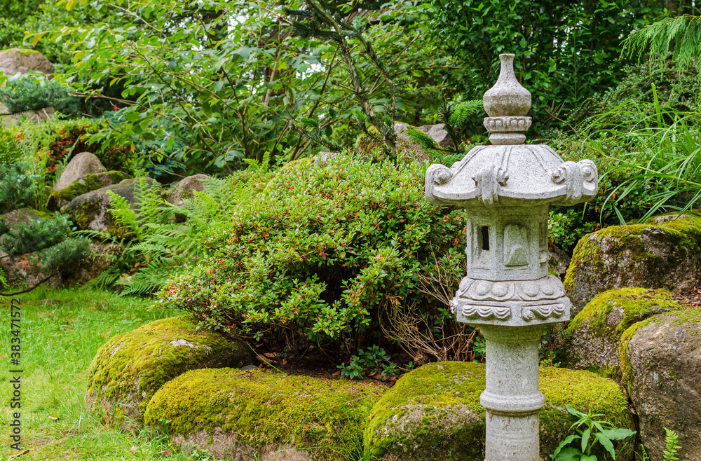 Old stone lantern in the Japanese garden. Poland, Shklarska poreba. Selective focus. Old stone lantern in the Japanese garden. Poland, Shklarska poreba. Selective focus.