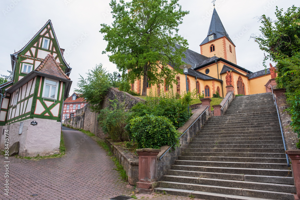 View of the St. Martin Church and a very narrow house in the old town of Bad Orb / Germany in the Spessart