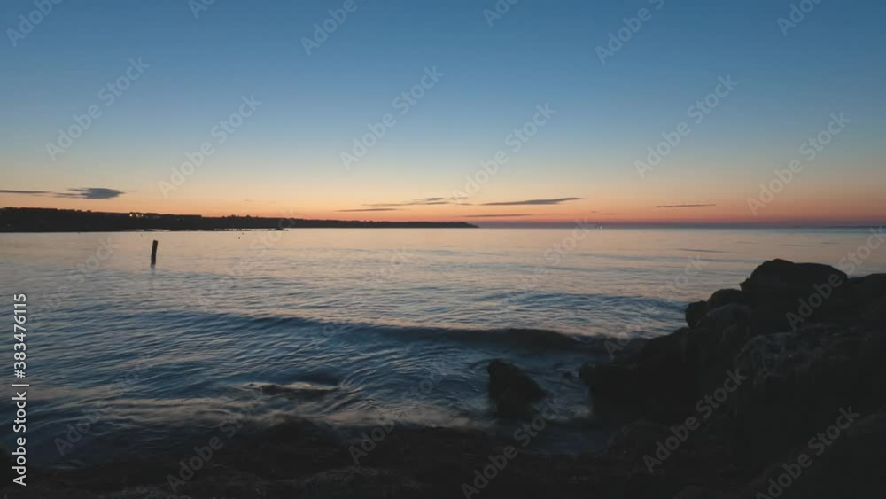 Sunrise time lapse from rocks with algae over the seawater in small bay. Calm sea and reflection on the water when the sun rising. Morning around Black sea. Sunrise time lapse from rocks with algae over the seawater in small bay. Calm sea and reflection on the water when the sun rising. Morning around Black sea.