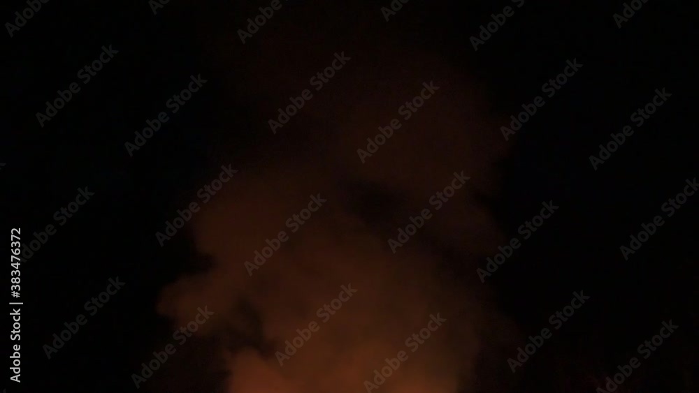 Flames and smoke late in the evening, slowing down the fire and smoke on a dark background.2020