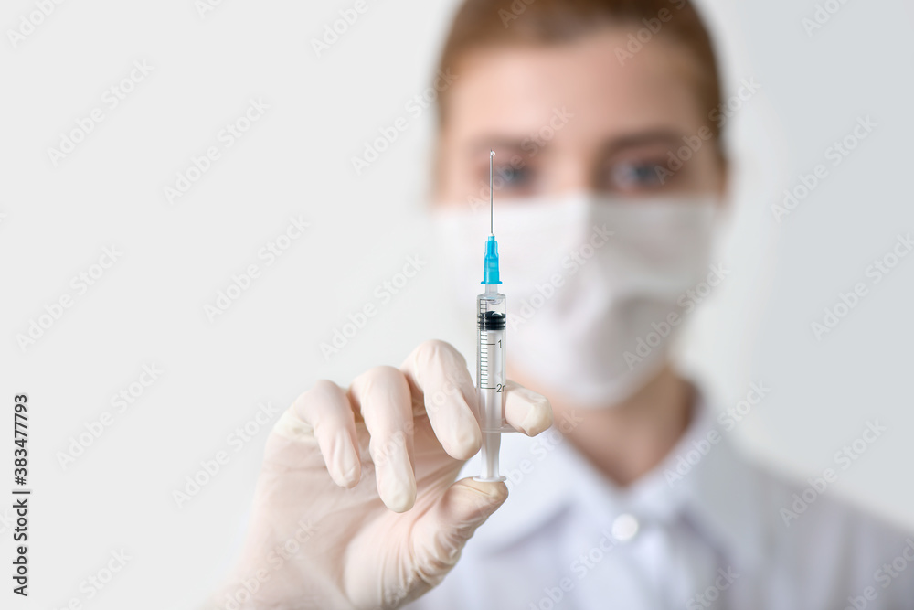 Doctor hand with injection syringe in hand. Doctor hand with injection syringe in hand.
