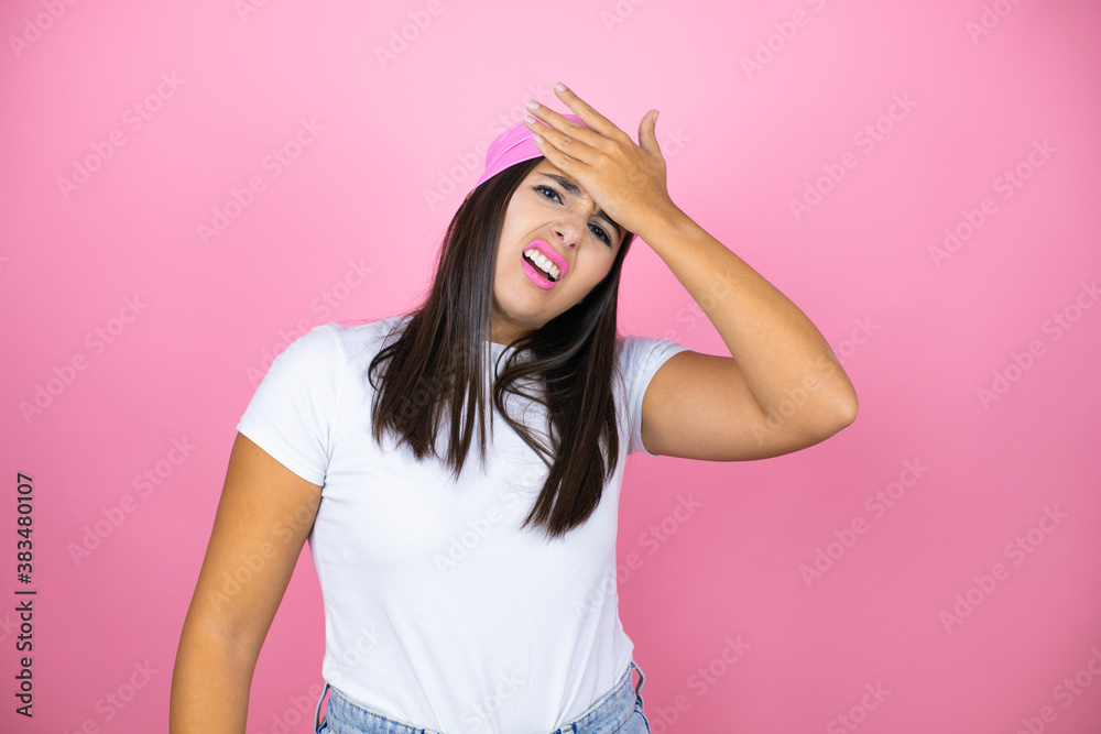 Young beautiful woman wearing pink headscarf over isolated pink background Touching forehead for illness and fever, flu and cold, virus sick Young beautiful woman wearing pink headscarf over isolated pink background Touching forehead for illness and fever, flu and cold, virus sick