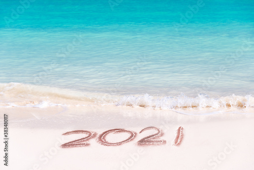 2021 written on the sand of a beach, travel 2020 new year concept