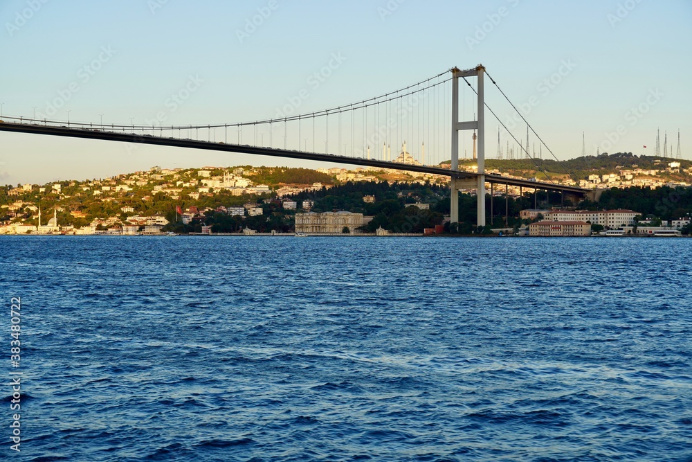 Tourist boats sail under the bridge in Istanbul. Traveling on the Bosphorus. Panoramic view, View of the First Bosphorus Bridge sailling Bosporus.