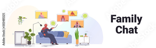 arab woman having virtual meeting with family members in web browser windows during video call online communication concept living room interior full length horizontal vector illustration © mast3r