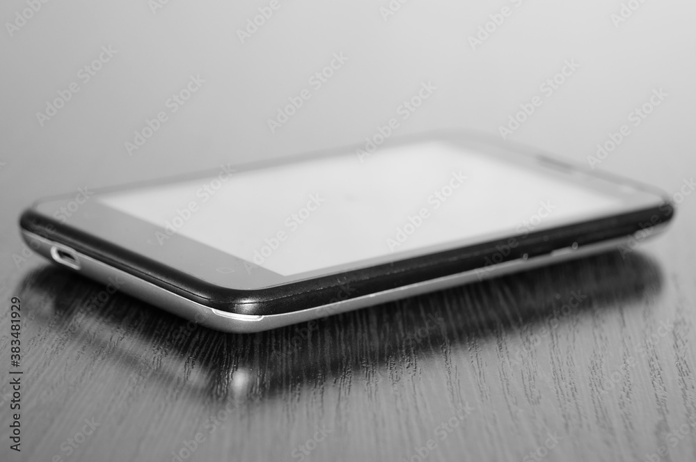 A close-up photo of a smartphone on the table. A close-up photo of a smartphone on the table.