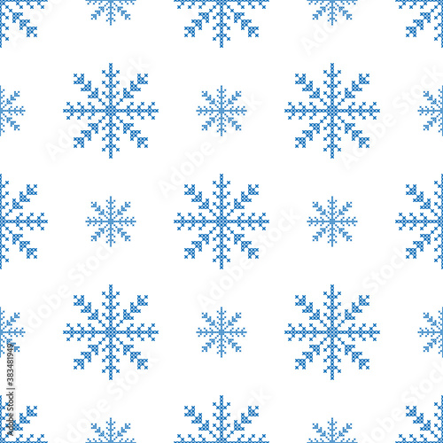 The seamless pattern with the big and small blue snowflakes is on the white background.