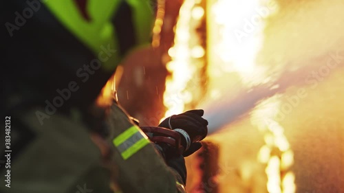 Fireman extinguish fire with the hose. Burning house fire drill. High quality 4k footage