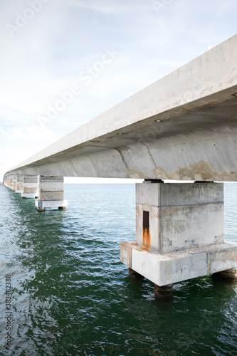 Concrete bridge over blue ocean water