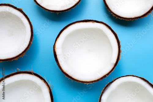 Half coconut on a blue background.