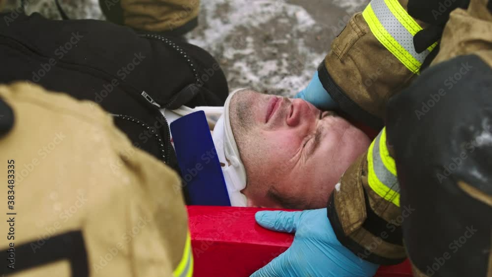 Firefghters lifting injured man. Rescue after car crash accident. High quality 4k footage Firefghters lifting injured man. Rescue after car crash accident. High quality 4k footage