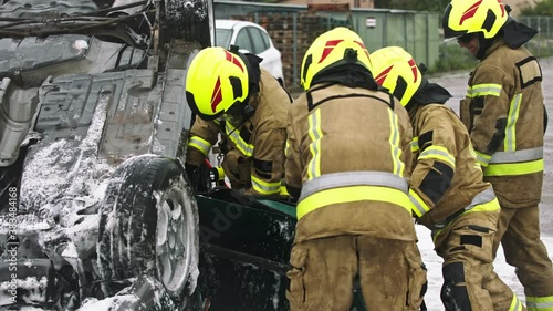 Firefighters cutting car doors to rescue viction of the car crash accident. High quality 4k footage photo