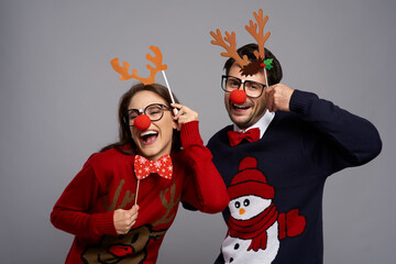 Portrait of couple with funny reindeer gadgets