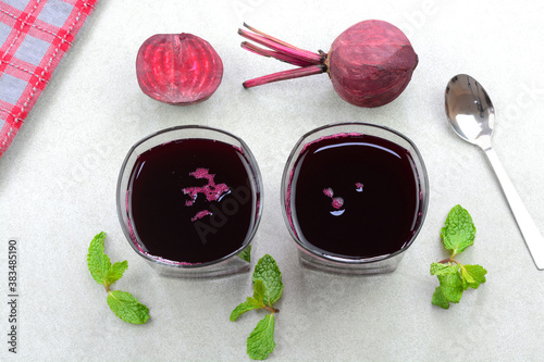 Beet root juice in glass cups with beet roots in the background photo