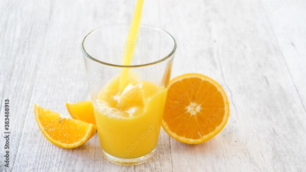 orange juice pouringin glass orange juice pouringin glass