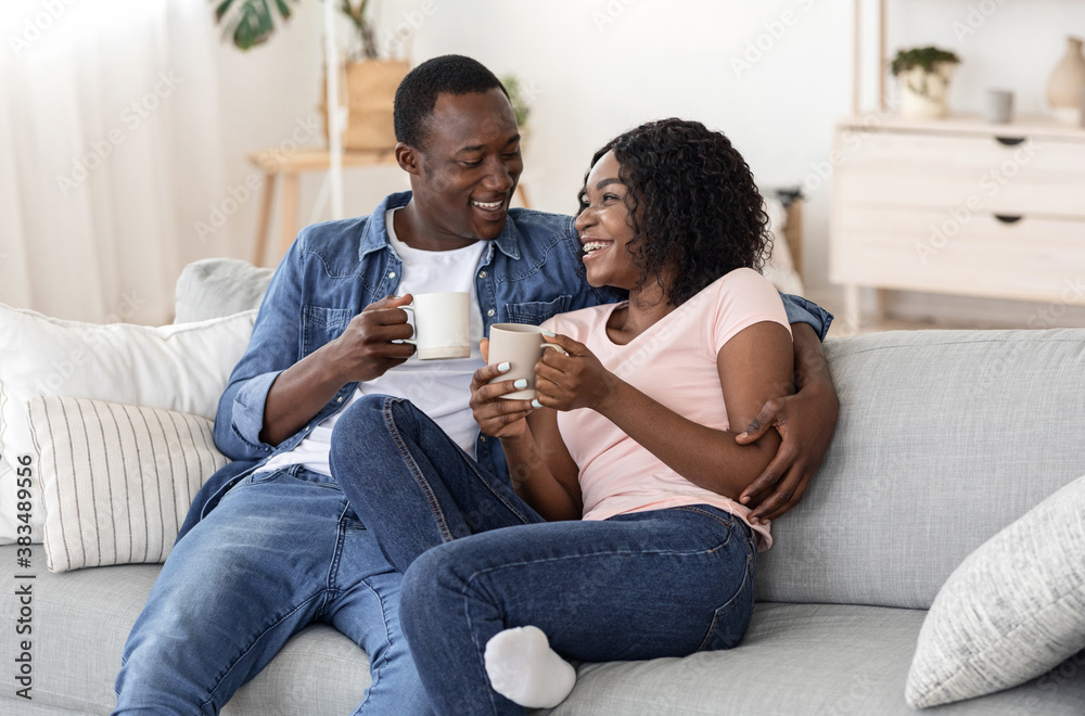 Young black man and woman enjoying weekend at home together Young black man and woman enjoying weekend at home together