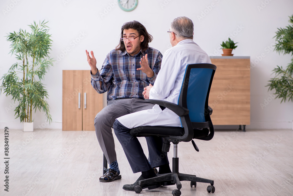 Young male patient visiting experienced doctor psychiatrist