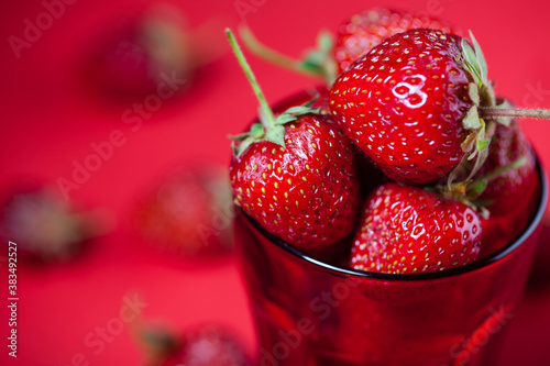 Studio photo of many strawberries on a dark textured surface. Selective focus  shallow depth of field.