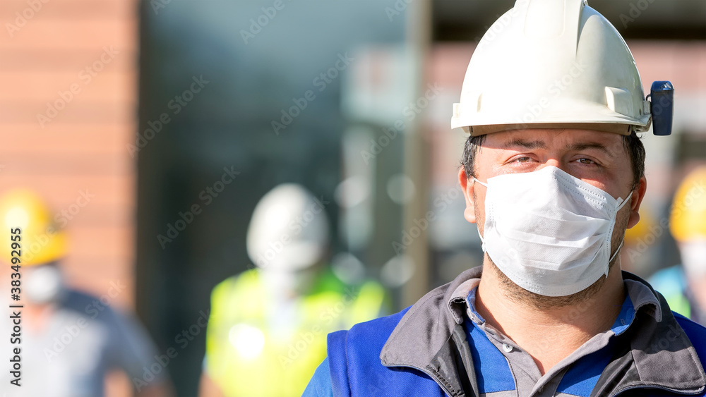 The construction workers with protective face mask for coronavirus (covid-19) in the factory. The construction workers with protective face mask for coronavirus (covid-19) in the factory.