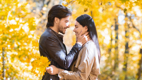 Man in love touching his woman face, dating in forest