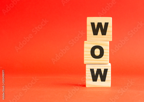 Wooden cubes with letters. For your design. Wooden cubes on a red background. Free space on the left.