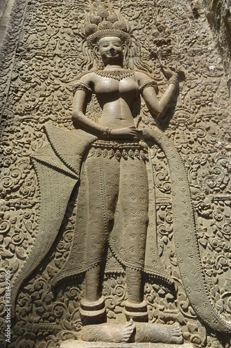 Carving of Apsara celestial dancer on ancient temple wall