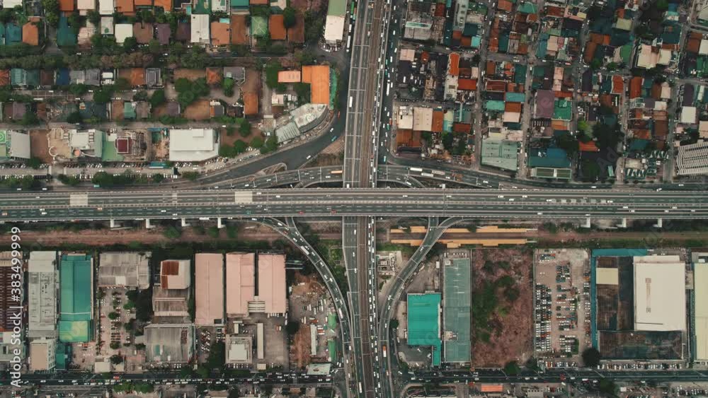 Top down slow motion of cars drive at cross freeway in aerial view. Highway traffic transportation at Manila city on Luzon Island, Philippines, Asia. Wonderful cityscape of downtown centre Top down slow motion of cars drive at cross freeway in aerial view. Highway traffic transportation at Manila city on Luzon Island, Philippines, Asia. Wonderful cityscape of downtown centre