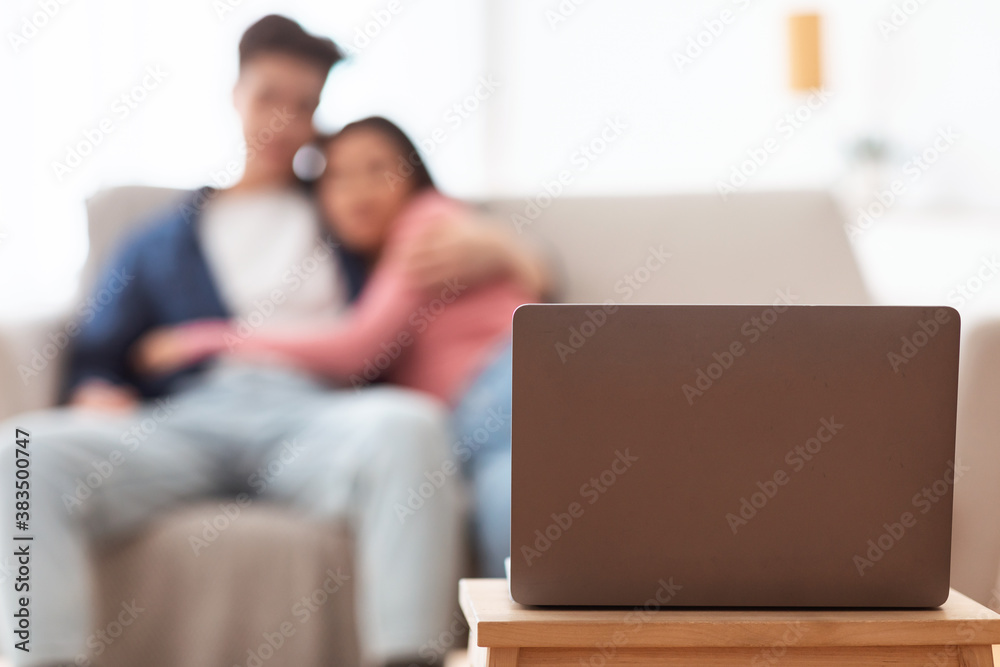 Couple Watching Movie On Laptop At Home, Focus On Computer Couple Watching Movie On Laptop At Home, Focus On Computer