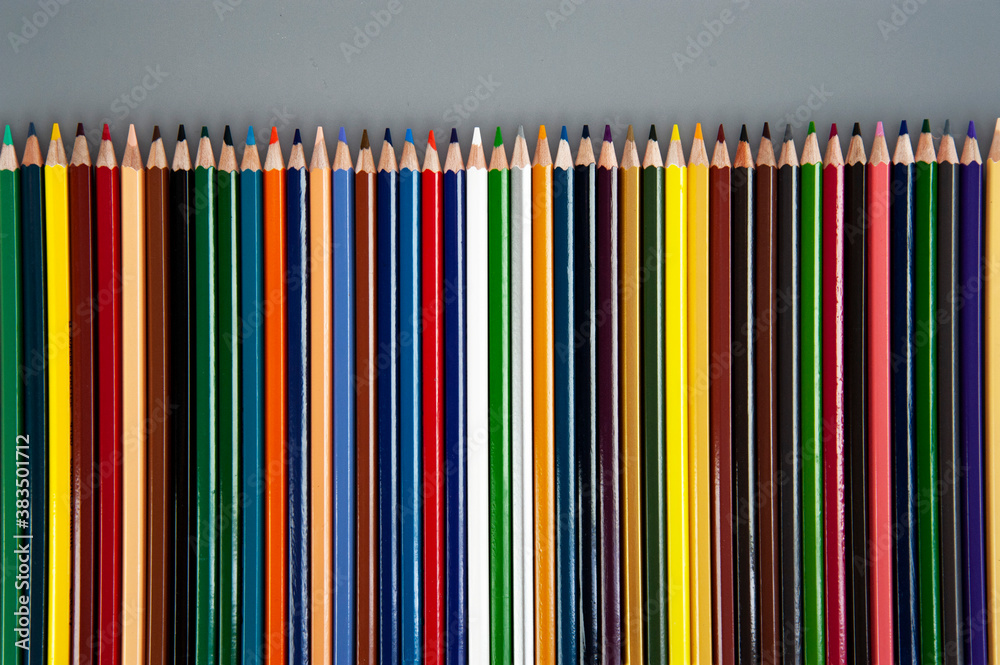 Multicolored pencils on gray background Multicolored pencils on gray background