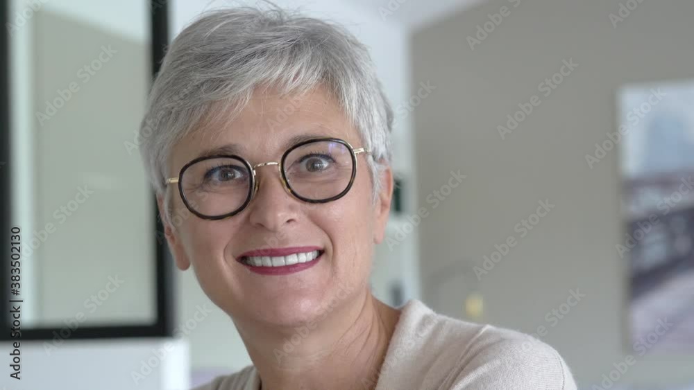 portrait of a beautiful smiling 55 year old woman with white hair portrait of a beautiful smiling 55 year old woman with white hair