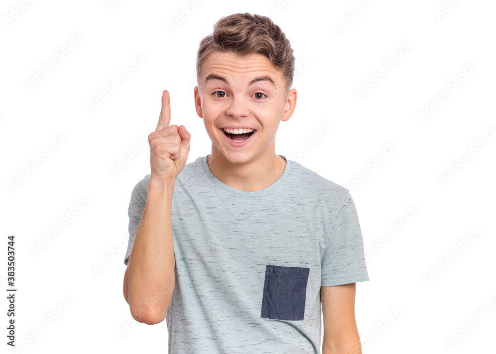 Cute teen boy pointing up, gesturing idea or doing number one gesture. Cute teen boy pointing up, gesturing idea or doing number one gesture.