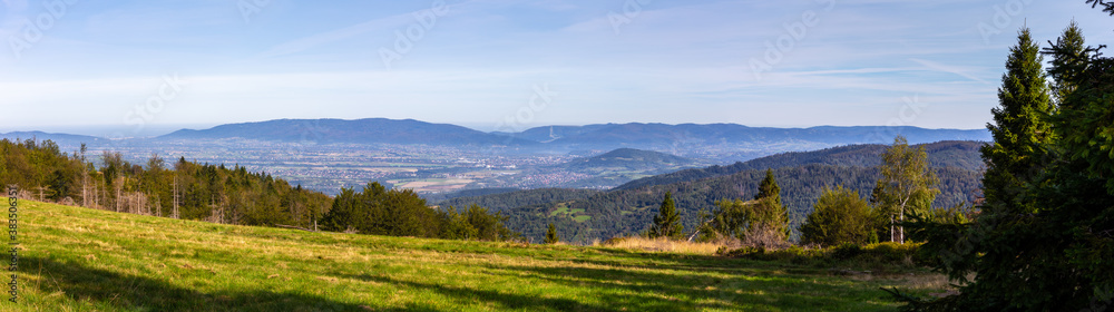 Zywiec Basin (Valley) panorama in Beskid Mountains, Poland, with green forests, meadows and Zywiec Lake, seen from the hill.