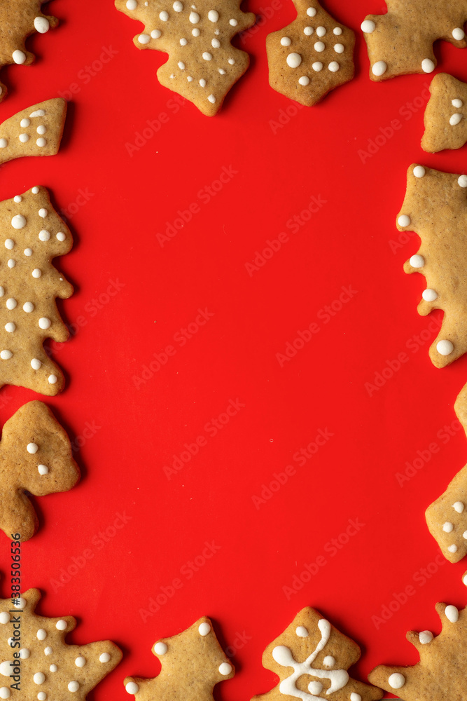 festive layout of New Year's christmas gingrerbread cookies on a red background. Merry Christmas and Happy New Year card
