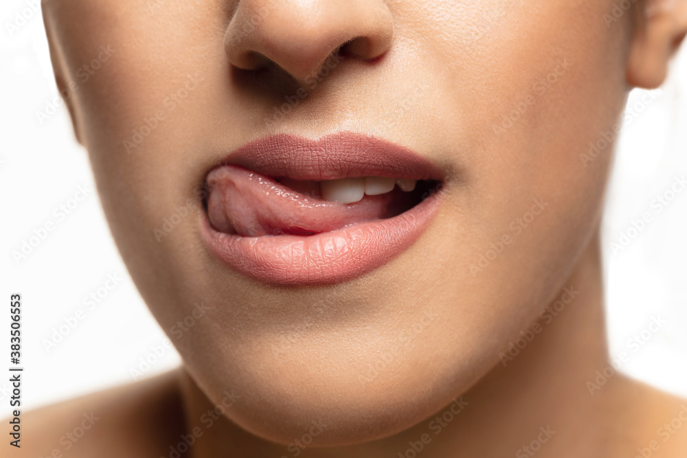Attractive. Close-up shoot of beautiful female lips with natural lipstick make up. Beauty, fashion, skincare, cosmetics, ad concept. Copyspace. Well-kept skin and natural fresh look. Healthy shiny.